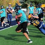 Forks Mario Reyes (46) dives in an attempt to stop the Sequim running back at Spartan Stadium where the two Jr high teams fought it out on the gridiron. Also for Forks are Kenneth Mckenney (63), Radly Bennett (88), and Adon Arrellano (59). Photo by Lonnie Archibald
