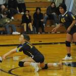 Spartan Katrina Clark digs it against Stevens of Port Angeles while Sophia Calderon looks on. Photo by Lonnie Archibald