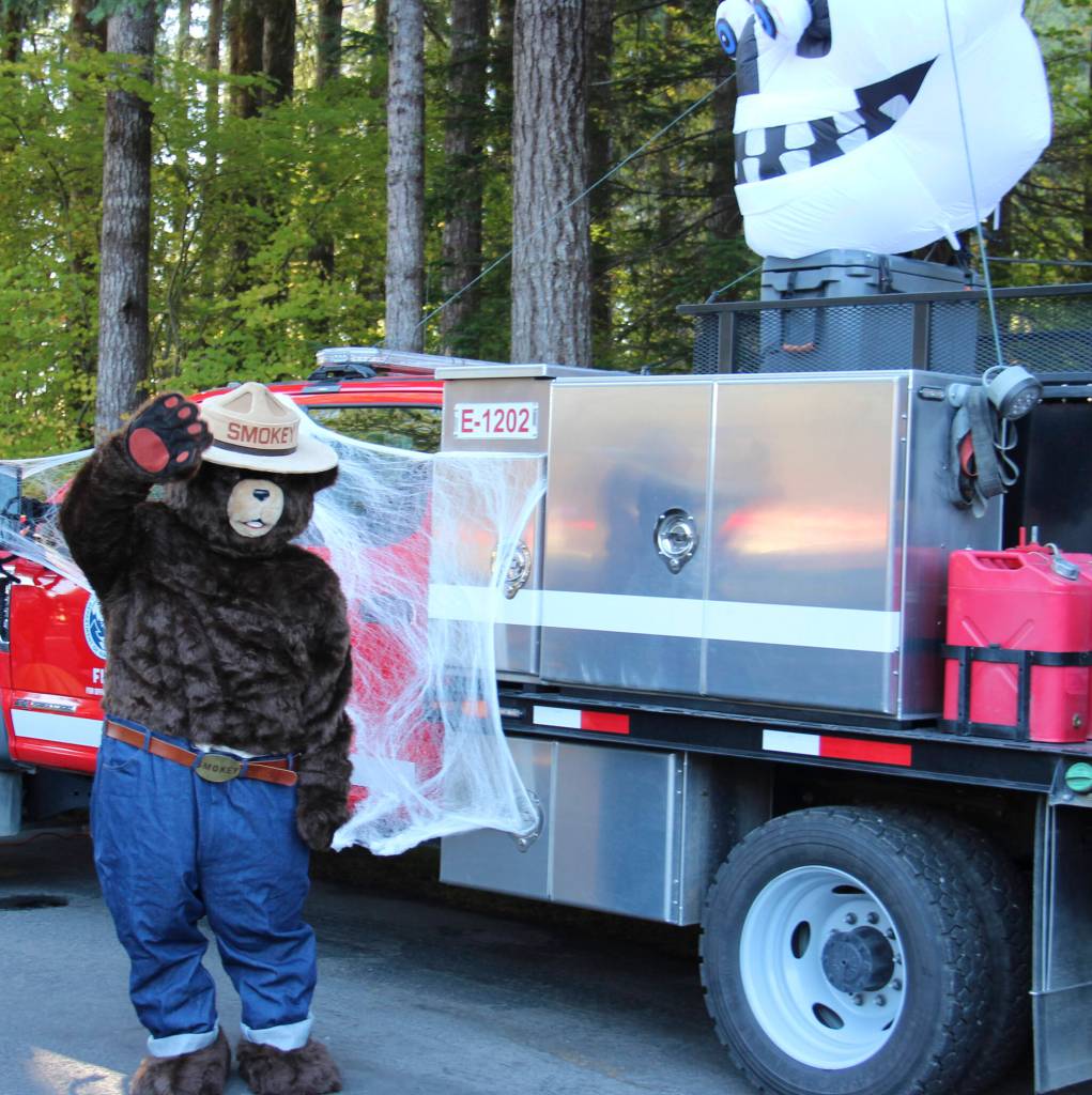 Smokey Bear is glad that the long dry summer is over and took a break by greeting truck or treaters on Saturday.