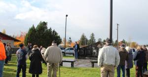 Joe Wright, Forks American Legion, center of photo, welcomed about 60 community members to the annual Veterans Day Ceremony at the Forks Transit Center last Saturday. Just before the ceremony the rain quit! and stayed away the entire ceremony. Meg Rasmussen offered TAPS. Pastor George Williams, Forks Bible Church, offered a short message and prayer. Photo Christi Baron