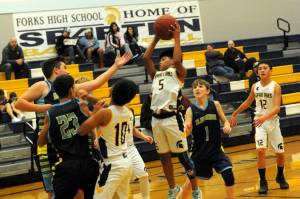In FMS action against Blue Heron, Thomas Penn (5) rebounds. Also in the action are Pedro Francisco (10) and Ryder Fletcher (12). Blue Heron defeated the Forks 7th grade 36 to 27. Forks led at halftime but ran out of gas by the fourth quarter as they only had five eligible players. Photo by Lonnie Archibald