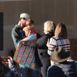 All family members of each family received a quilt. Here Tawnya Rowley, standing nearest back to the camera, looks on as a quilt is wrapped around a family member. Rowley also took a moment to thank her employer, Mariposa House, for working with her schedule so she was able to complete her required hours of work.