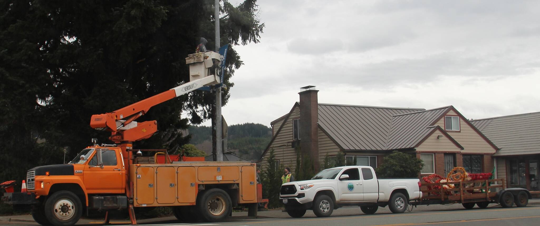 City of Forks Public Works crew members worked last week to get the downtown Christmas decorations up. Photo Christi Baron
