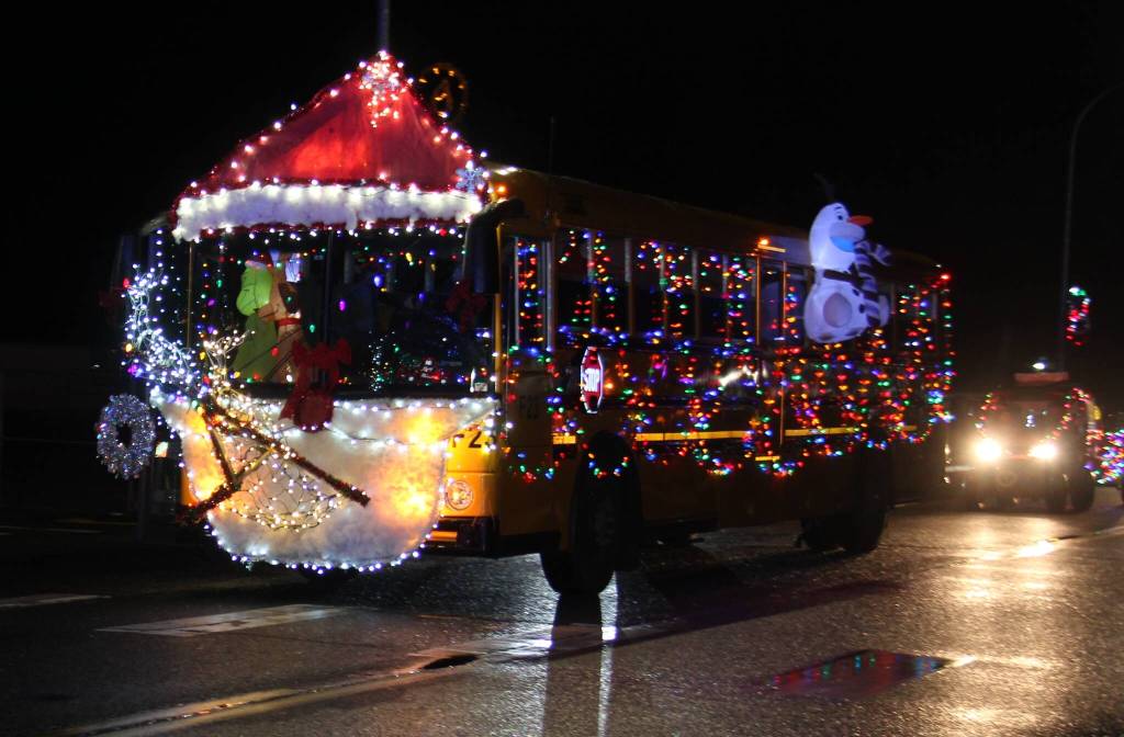 The Quillayute Valley School District bus drivers went all out decorating this school bus for the annual Twinkle Light Holiday parade held Saturday night in Forks. The bus drivers even took the opportunity to add a banner to the back of the bus advertising they desperately need more bus drivers!