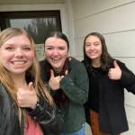 NHS Vice President, President, and Secretary delivering donations in a rainstorm! Photo Erame Tost