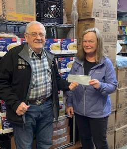 Forks Elks Lodge #2524 member Glenn King recently presented Forks Food Bank Executive director, Pat Soderlind, with a check for $1,500. The funds will be appropriated for future holiday food baskets. In addition to being an Elks member, King is also a Food Bank volunteer. Submitted photo
