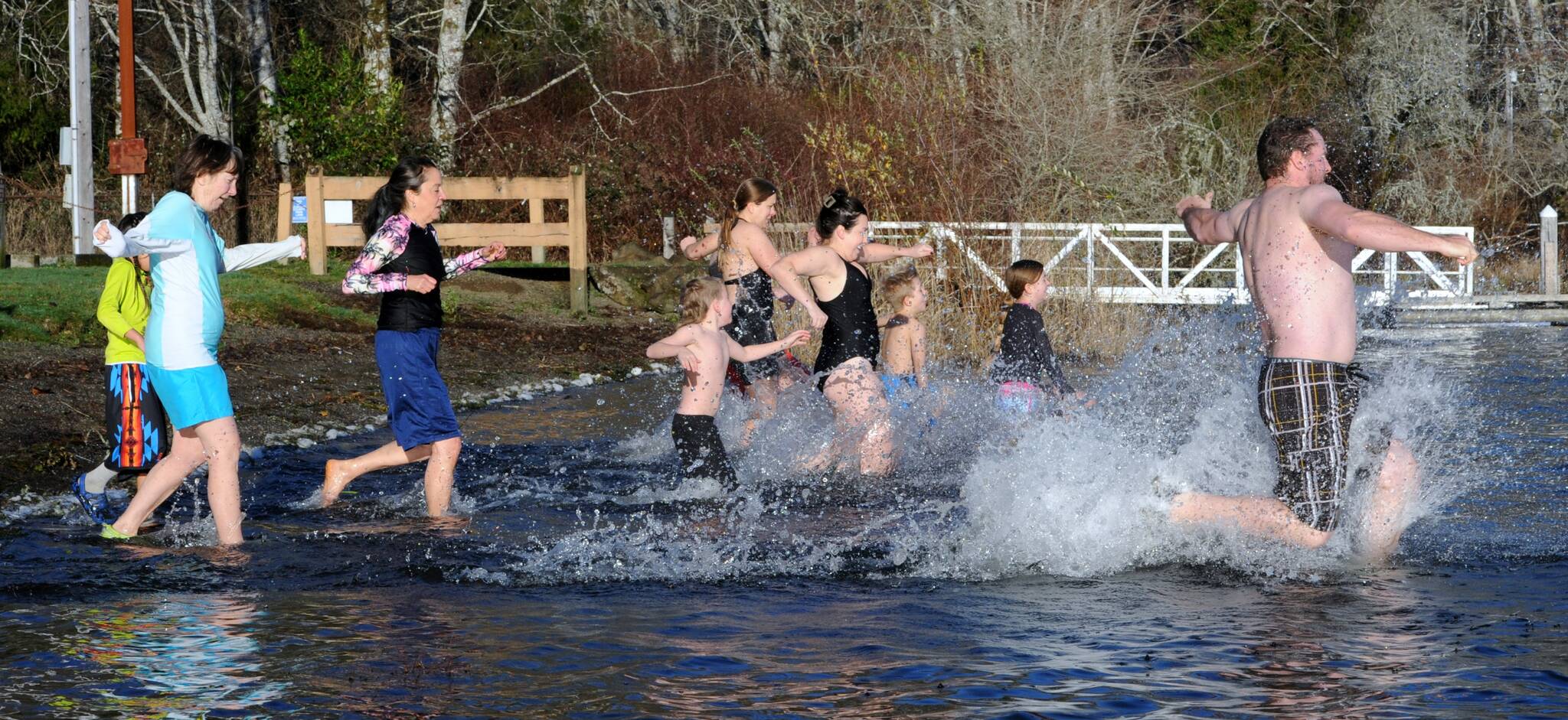 With frost on the lawn, these brave souls entered the cool waters of Lake Pleasant on New Years morning in the annual polar bear plunge. Photo by Lonnie Archibald