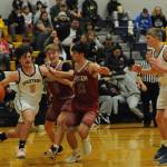 Landin Davis drives against the Grizzlies while teammate Titus Rowley looks on. Photo by Lonnie Archibald