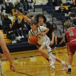 Spartan Kyle Lohrengel drives against the Grizzlies while Landin Davis looks on. Photo by Lonnie Archibald