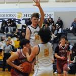 Landen Olson (25) and Landin Davis on defense against Hoquiam. Photo by Lonnie Archibald