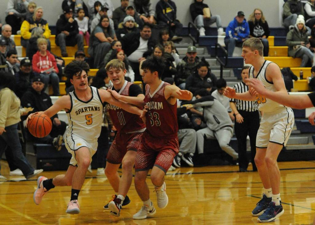 Landin Davis drives against the Grizzlies while teammate Titus Rowley looks on. Photo by Lonnie Archibald