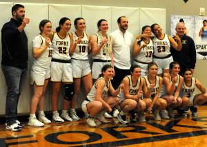 Spartans basketball players take a moment for family and friends to capture the moment with a team group photo …after their victory Friday night.
Forks Spartans front row from left: Bailey Johnson, Chloe Gaydeski, Karee Neel, Molly Hampton, and Skye Hestand.
Back row from left: Assistant coach Cameron LeDuke, Fynlie Peters, Brynn Daniels, Avery Dilley, Keira Johnson, Head coach David Hurn, Janessa Ramos, Alyna Centeno, and volunteer coach Ron Hurn. Photo Lonnie Archibald