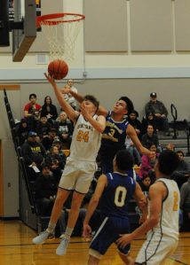 Spartan Landen Olson (24) and senior Aidan Salazar (2) in action against Chief Leschi who defeated the Forks 54 to 51 by way of a closing seconds three-point shot. Photo by lonnie Archibald