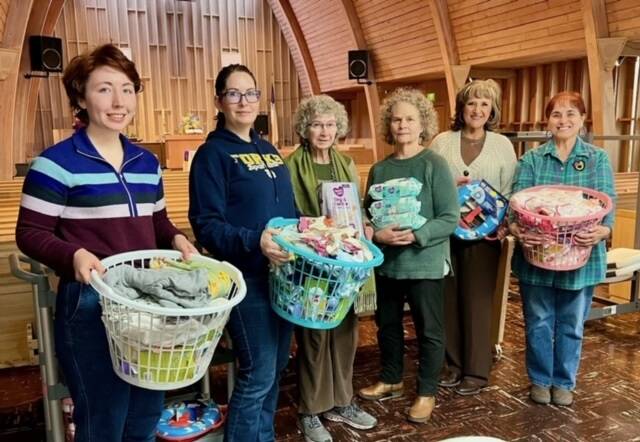 The Soroptimist International of the Olympic Rain Forest gifted twelve baby layette baskets and other necessities to The Caring Place at their March meeting. Pictured Sydney Scelzi, Sarah Hansen, Rita Calamar, and Pam Cantrell from Caring Place, Elena Friesz, and Sharla Fraker. Submitted photo