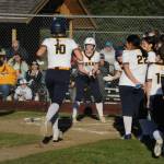 Spartan Avery Dilley is greeted at home as she hits the ball over the left-field fence for a home run. Photo by Lonnie Archibald