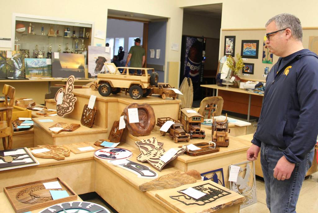 Brian looks over the many amazing items that were created at the Olympic Corrections Center Wood Shop. Each year they go above and beyond to help raise money for FHS grads.