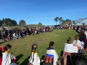 What a difference a year makes …last year Quileute students, tribal members and spectators battled wind and rain at the annual Welcome the Whales ceremony …this year the weather was amazing! Here students perform a dance and song as a very large crowd looks on. Submitted photo