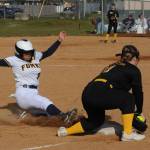 Spartan Donny Williams turns up the soil as she slides safely into third ahead of the throw in this contest in which the Forks Jvs defeated the North Beach varsity 20 to 5 at Tillicum Park. Photo by Lonnie Archibald