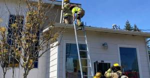 CCFPD#1 firefighters head up on the roof at Gingers Closet located at 170 Sol Duc Way. Submitted photo
fire