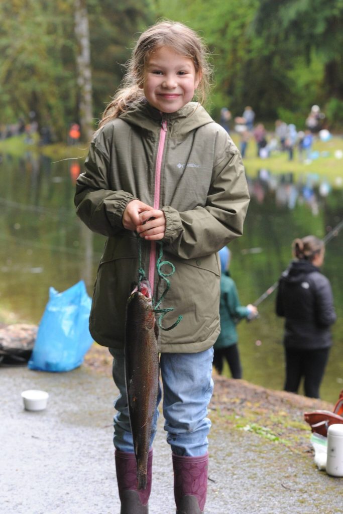 Mallie Daniels looks happy with her large trout.