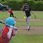 Scrap Yard Dawgs pitcher Chazlynn Fryberg pitches to the Pride while a Pride runner leaves second base.