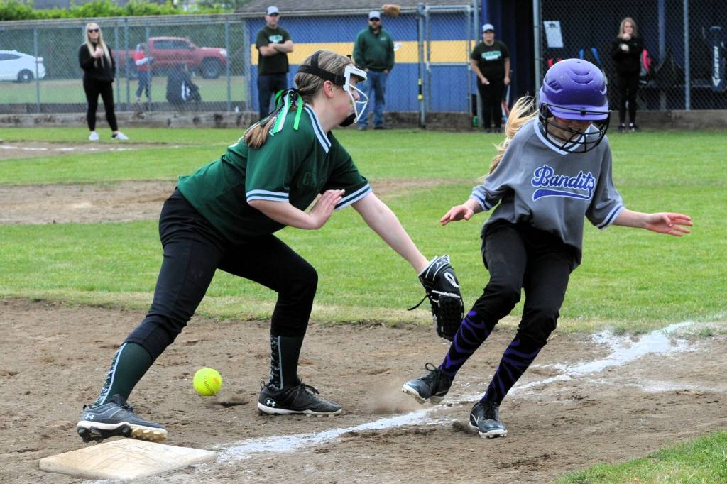 Charge third baseman Hailey Rondeau attempts to tag Bandits runner Lillian Crippen at third base. Of course, the ball must be secured in the hand or mitt for a called-out.