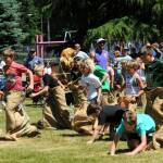 There were many ups and downs during the eight and nine-year-old gunny sack races on Sunday, July 7 at Tillicum Park. Photo by Lonnie Archibald