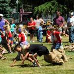These 6-7-year-olds learn that it takes much skill to keep running with your partner during the three-legged races. Photo by Lonnie Archibald