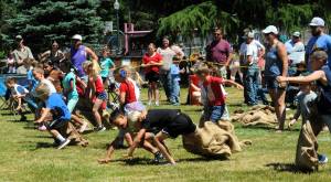 These 6-7-year-olds learn that it takes much skill to keep running with your partner during the three-legged races. Photo by Lonnie Archibald