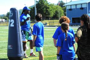 Former Seattle Seahawks special teams captain and current coach Neiko Thorpe instructs athletes.