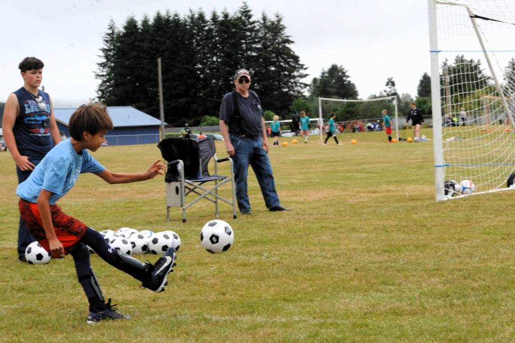 Howard Huskins, age ten, showed good toe-to-ball contact as he was on target.