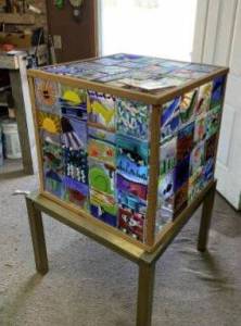 PCSC Historical Arti-fact Unearthed
Stored between the wading boots, pulaski axes, and maps, PCSC unearthed a treasure: a glass artwork donated by the students of Forks High School a decade ago. Constructed of 64 panels of fused glass and fir framing, the glass was made by students under the direction of high school teacher Wendy Bennett and assembled by Julian Ortiz, with the help of PCSC staff Joe Thompson and Alex Huelsdonk. Come see this amazing piece of art displayed at the PCSC Fish N Brew, on Oct. 5 at the Kitla Roundhouse, 3-7 pm. More details at: www.pacificsalmoncoalition.org