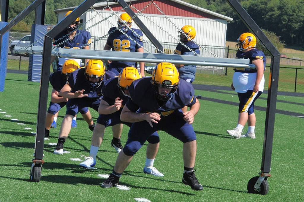 Forks High School linemen go through drills in preparation for the upcoming football season. Photo by Lonnie Archibald