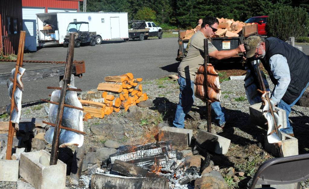 Guy Ruble and Lyle Neilson prepare salmon for the luncheon during the Truckers picnic. In addition to a great lunch the Lions provided a beer garden. Photo by Lonnie Archibald