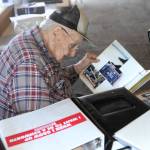 Senior retired trucker Clark Browning looks over trucking and logging memorabilia during the Truckers picnic held Saturday at the Roundhouse in Forks. Photo by Lonnie Archibald