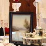 A vintage Norwegian Bunad apron once worn by Pastor Pam Hunters ancestor can be seen on the left; a vintage tea set and photos were displayed by Linda Keen.