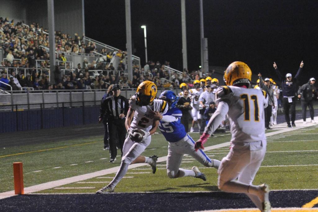 Forks coach Trevor Highfield signaled TD and he was correct as Spartan Noah Foster pulled in a Forks pass for the touchdown in front of a large crowd at Spartan Stadium putting Forks ahead 14 to 13 at the half against the Adna Pirates. Also in the photo is Spartan Cash Barajas (11). Photo by Lonnie Archibald