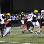 Forks Kaden Ward sacks Ravens quarterback Chris Quintana at Spartan Stadium where a stinger Forks defense played a big role in defeating Raymond-South Bend 35 to 8. Story page 6. Photo by Lonnie Archibald