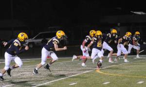 Spartan kicker, DeAnthony Davila kicks off against the Ravens in this contest won by Forks 35 to 8 on the turf of Spartan Stadium. Davila was superb in his kickoffs and the kicking of extra points this season. Also on the kick-off from left are Landon Thomas, Jeremy Hutto, Kade Highfield, Gage Willenbrink, Jai Leavitt-Ward, and Kaden Ward. Photo by Lonnie Archibald