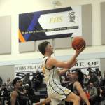 Photo by Lonnie Archibald
Forks Landen Olson drives and scores against Raven defenders January 7 in Forks were the Spartans defeated Raymond-South Bend 67 to 45 in a hard fought contest in which most of the game was much closer than the final score. Trailing the play is Spartan Noah Foster.