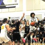 Photo by Lonnie Archibald
Forks Bubba Hernandez-Stansbury scores against the Ravens while teammates Brody Lausche and Ty Rowley look on. After three quarters of hard fought basketball, Forks put the game away in the 4th quarter with a tight defense, good rebounding and scoring to take this contest 67 to 45 over league rivals Raymond-South Bend.