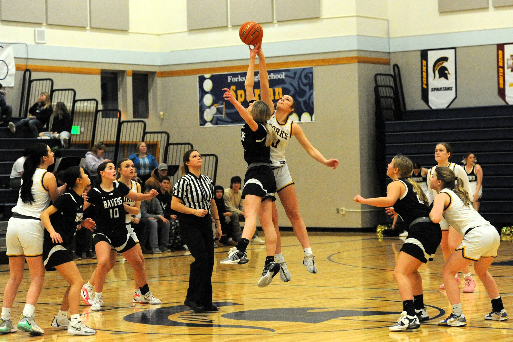 Photo by Lonnie Archibald
Forks Avery Dilley jumps against Raymond South Bend in the Spartan gym where the Ravens outlasted the Spartans by way of a 54 to 47 score in Pacific 2B league action. Forks had defeated the Ravens earlier in the season on the Ravens home cout but this contest was reversed as too many turnovers and fouls hampered the Spartans chance to win this hard-fought contest, especially in the first half of play. Other Spartans from left are Chloe Gaydeski, Karee Neel, Fynlie Peters, and Bailey Johnson.