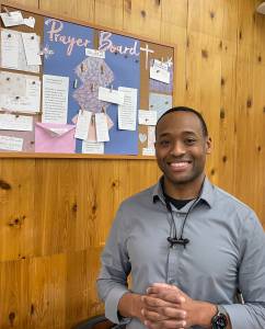 Tilus stands in front of the newly added Prayer Board at the pharmacy, where anyone can share a prayer request. We start our day with prayerwho doesnt need a little prayer sometimes? he said.