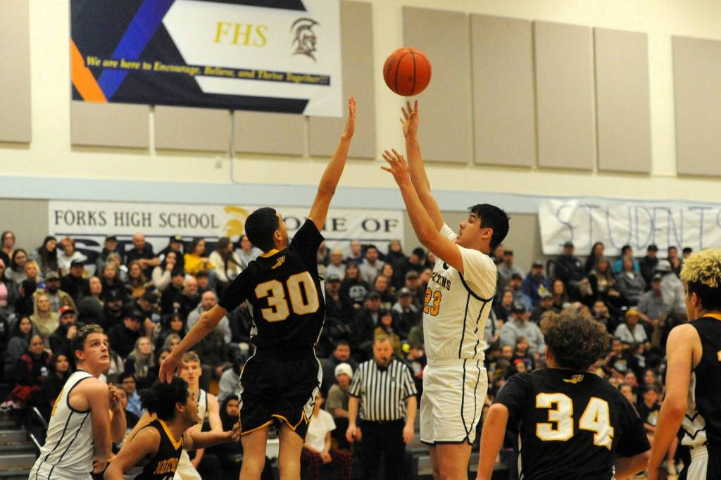 Senior Juan Terrones puts up a shot during Senior Night on Jan. 31 in the Spartan Gym where Forks easily defeated North Beach.