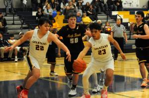 Photo by Lonnie Archibald
In Spartan JV action David Ward (22) and Kaden Ward (23) competed for ball control against North Beach who Forks defeated 68 to 30 in the Spartan Gym.
