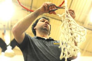 Photo by Lonnie Archibald
Spartan head coach Keith Weekes cut down the remainder of the net after the varsity boys had each taken a strand. The Forks boys won the Pac 2B league with a win over North Beach at home on Senior night.