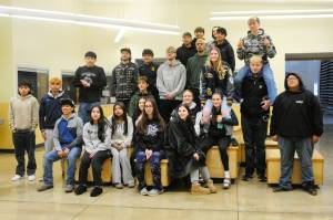Forks wrestlers pose for photos before departing to Tacoma last Thursday for the 2B state championships. Photo by Lonnie Archibald
