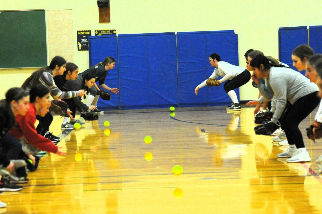 Photos by Lonnie Archibald
With wet fields, the Spartan softball team warmed up in the auxiliary gym in preparation to the home opener with Sequim Friday, March 14 at Tillicum Park. The double header is scheduled to begin at 3 p.m.