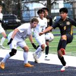 Forks Eduardo Calmo kicks away from Roughriders Matthew Miller and Sebastian Bautista on the Spartan Stadium turf on Thursday, March 13. The next scheduled game for Forks is Thursday, March 20 at 6 p.m.