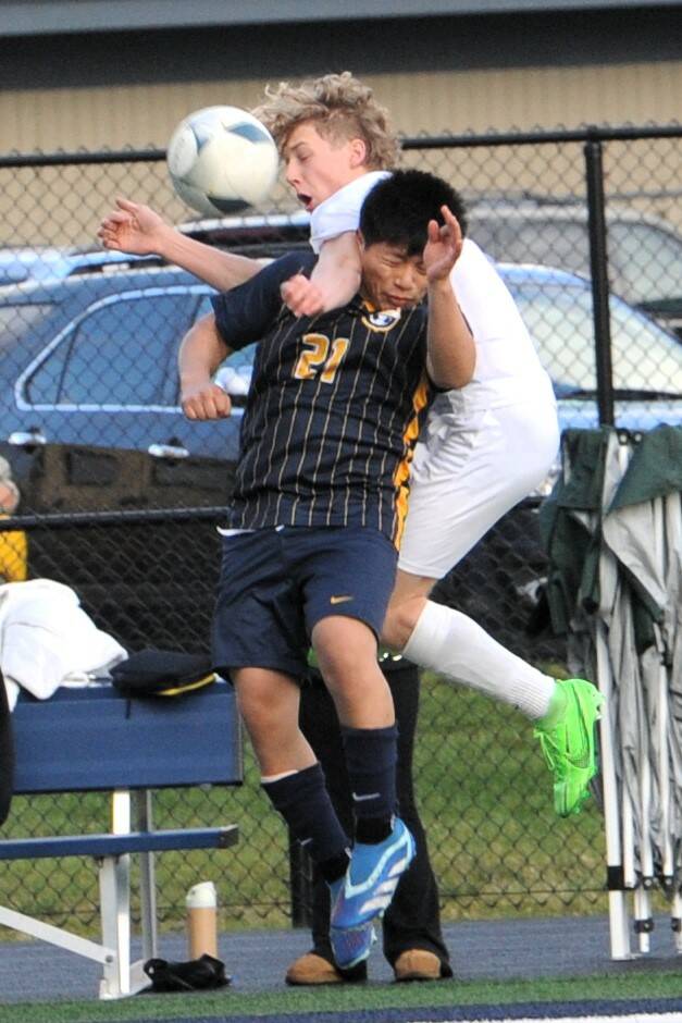 Spartan Nery Jeronimo (21) clashes with Roughrider Jake Weaver during the soccer match held at Spartan Stadium where Port Anjgeles defeated Forks 2 to 0.